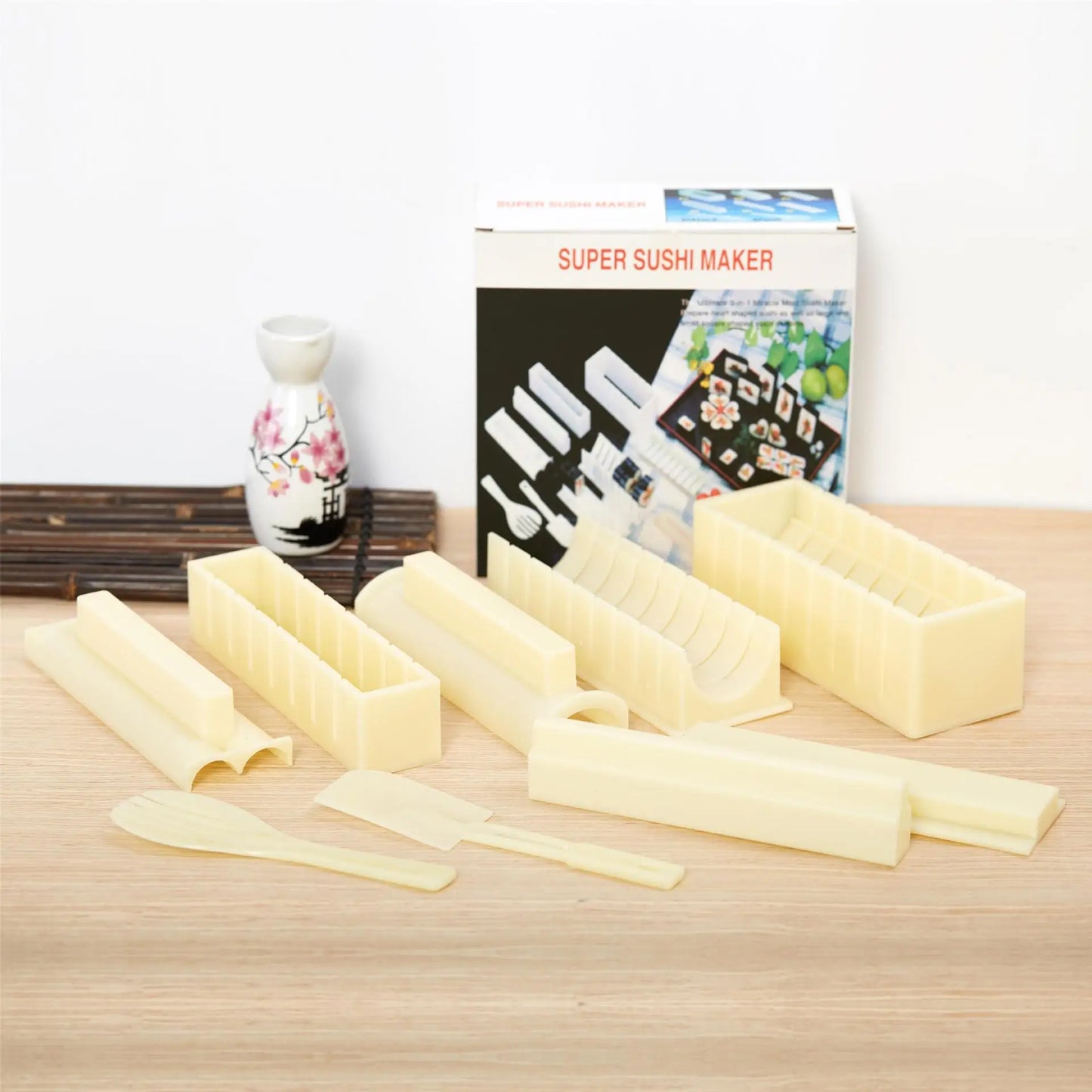Sushi making kit with various sushi molds, fork, spatula, and utensils for making homemade sushi. Japanese sushi mold.
